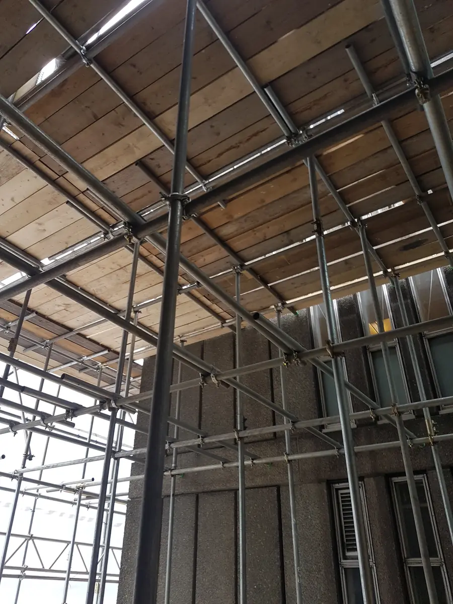 A boarded scaffold deck seen from below